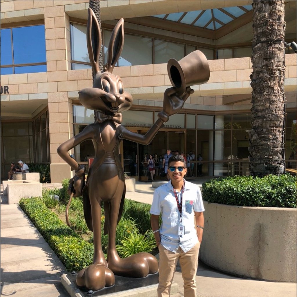 Brandon next to a Bugs Bunny statue at Warner Bros.